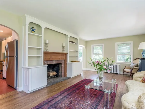 a living room with furniture fireplace and a window