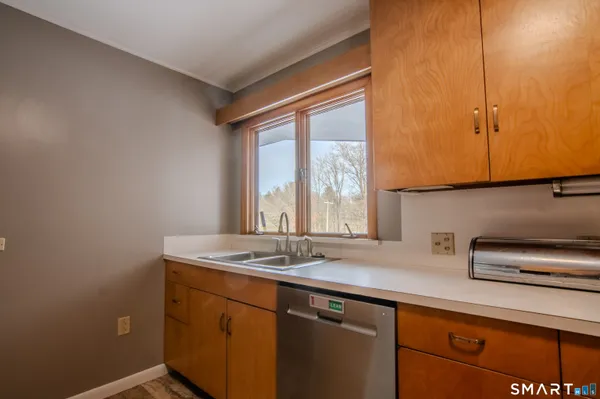 a view of a kitchen with sink and window