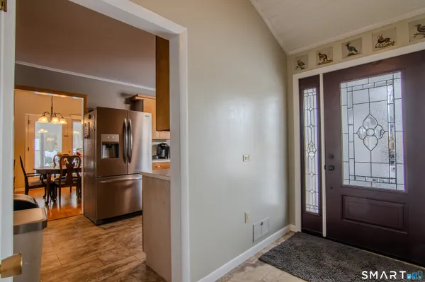 a kitchen with stainless steel appliances granite countertop a refrigerator and a stove top oven