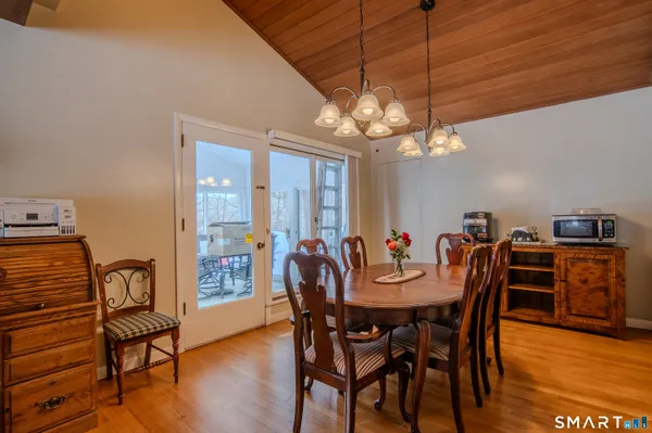 a living room with furniture flat screen tv and large window
