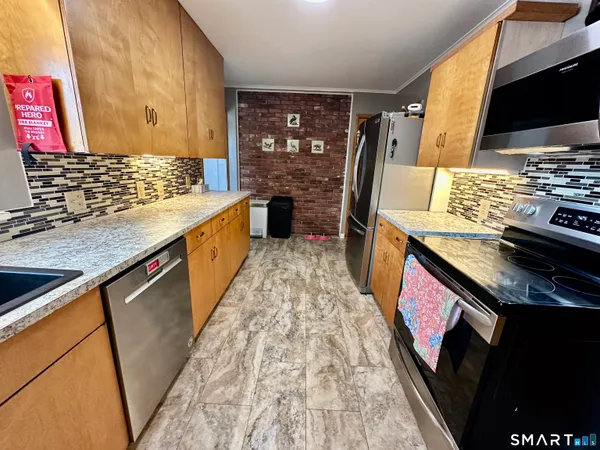 a kitchen with stainless steel appliances granite countertop a stove and a sink