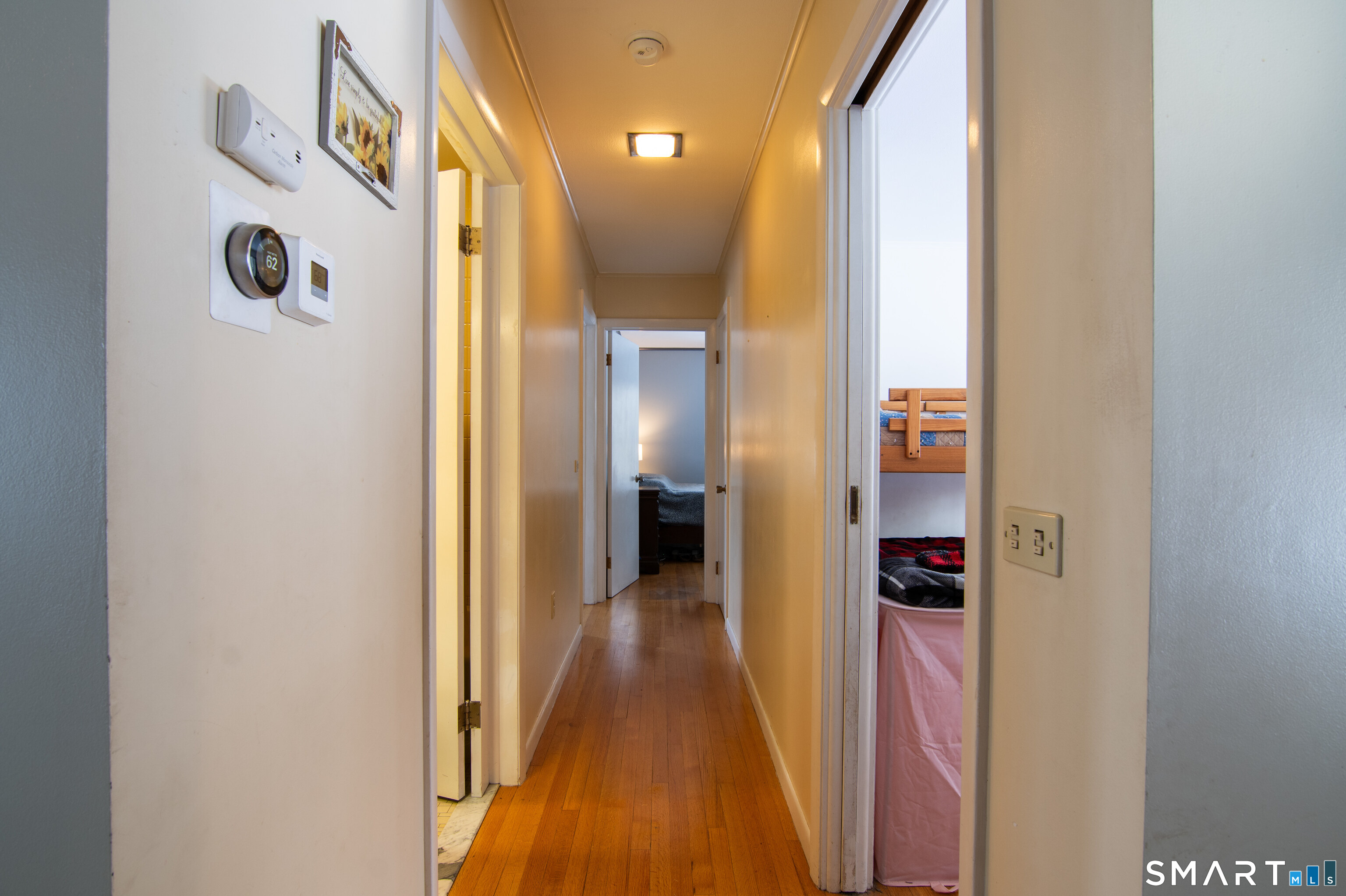 310 Roseland Park Road Woodstock, CT 06281 - Photo 21 of 43 a view of a hallway with wooden floor and a bathroom