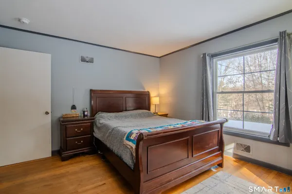 a bedroom with a bed and a window