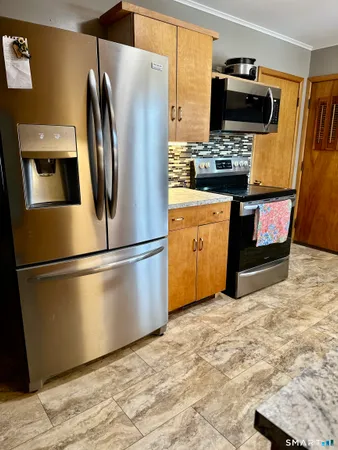 a kitchen with stainless steel appliances a refrigerator stove and microwave