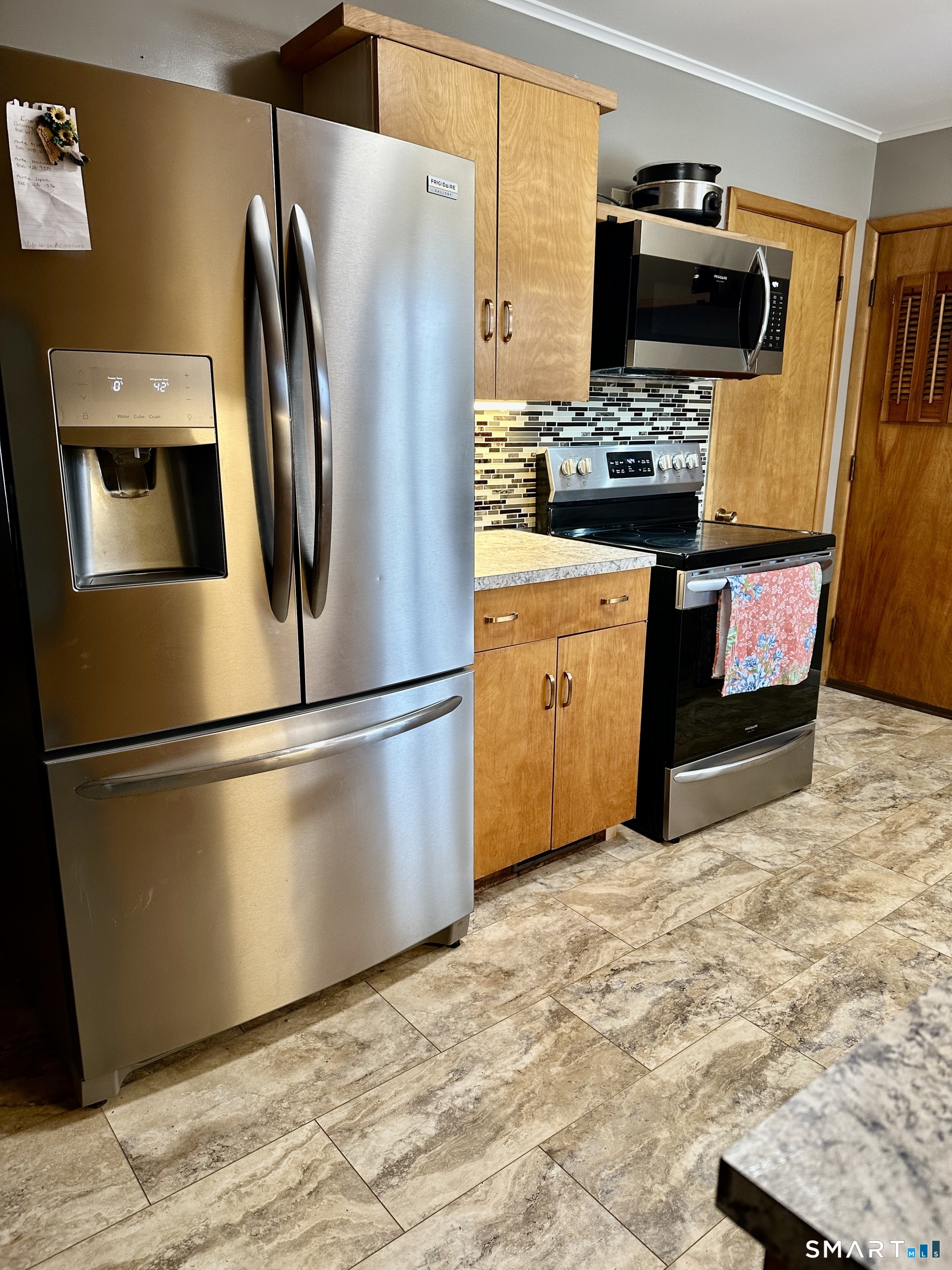 310 Roseland Park Road Woodstock, CT 06281 - Photo 3 of 43 a kitchen with stainless steel appliances a refrigerator stove and microwave