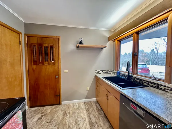 a kitchen with sink a window and cabinets