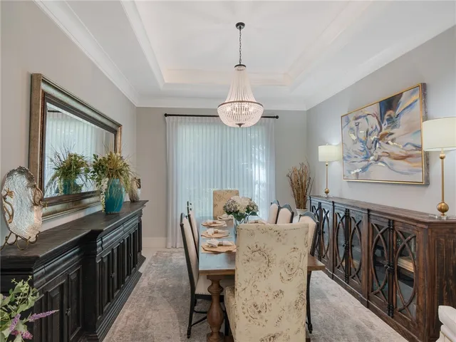 a view of a dining room with furniture and a chandelier