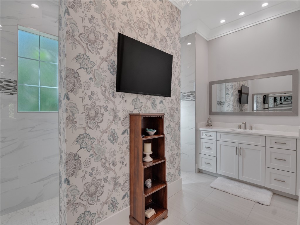 1025 Andarella Way Vero Beach, FL 32963 - Photo 19 of 36 a living room with a fireplace and a flat screen tv