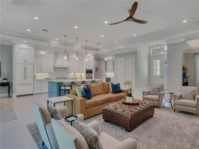 a living room with furniture and a ceiling fan