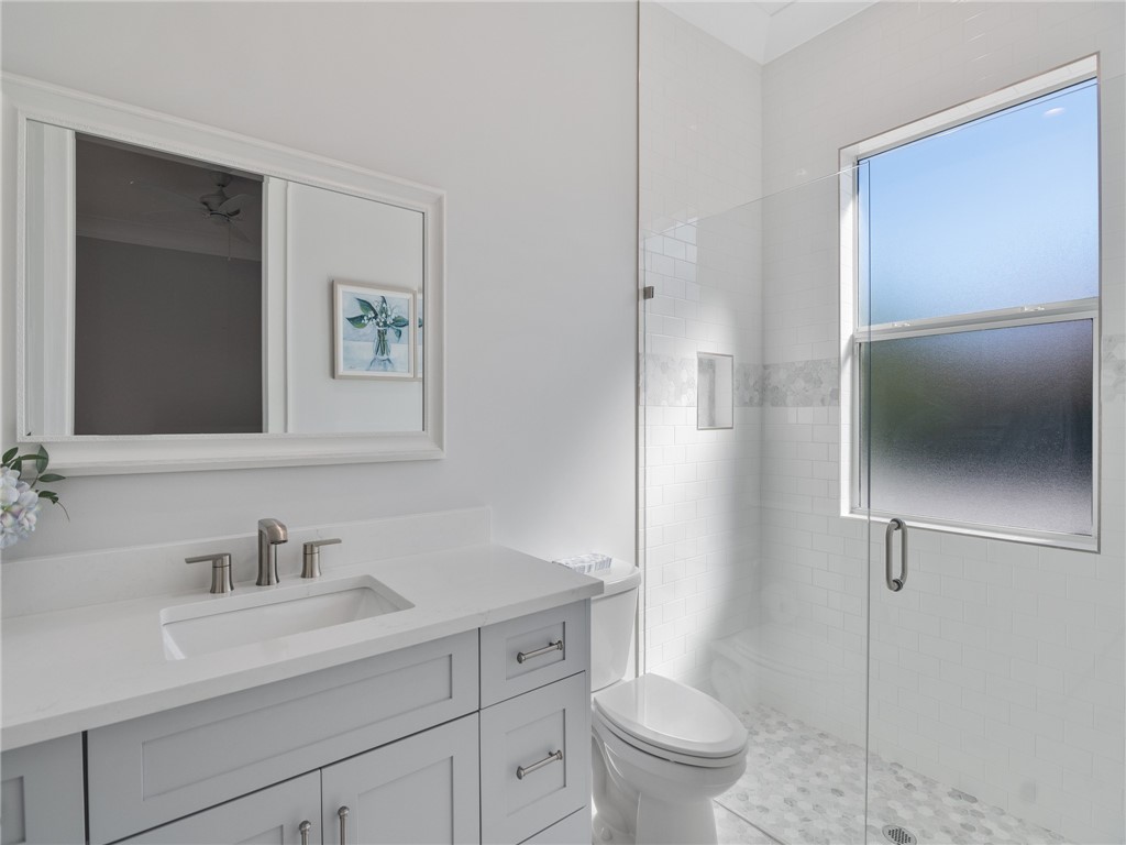 1025 Andarella Way Vero Beach, FL 32963 - Photo 23 of 36 a bathroom with a sink toilet and shower