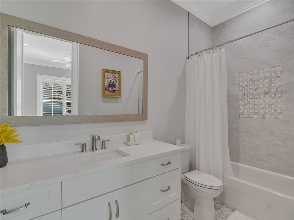 1025 Andarella Way Vero Beach, FL 32963 - Photo 25 of 36 a bathroom with a sink mirror vanity and toilet