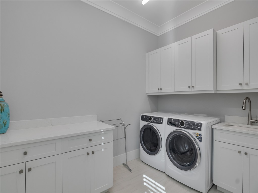1025 Andarella Way Vero Beach, FL 32963 - Photo 28 of 36 a utility room with sink dryer and washer
