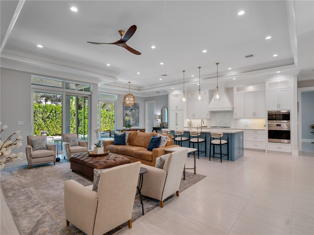 1025 Andarella Way Vero Beach, FL 32963 - Photo 3 of 36 a living room with furniture kitchen area and a large window