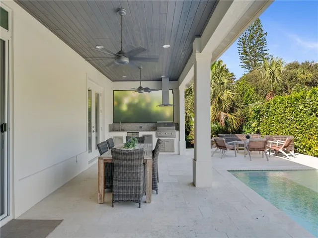 a dining room with furniture and a chandelier