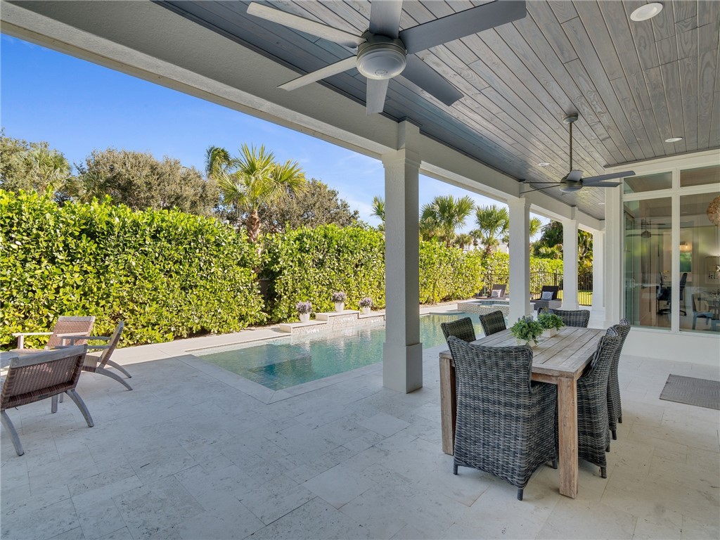 1025 Andarella Way Vero Beach, FL 32963 - Photo 32 of 36 a dining room with furniture and a floor to ceiling window
