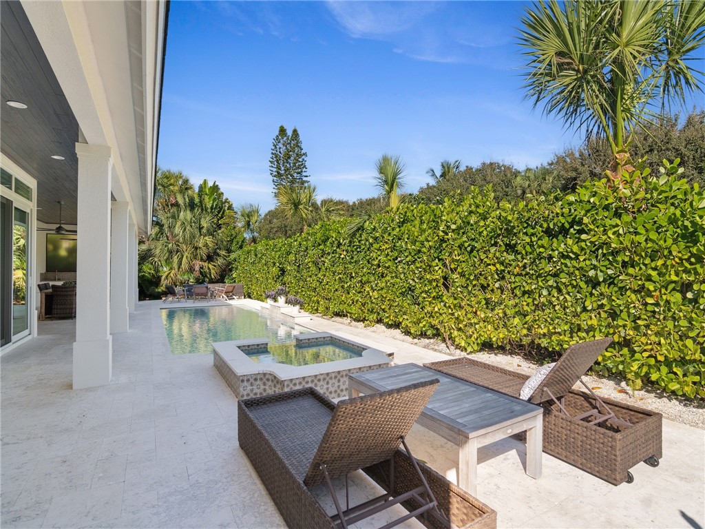 1025 Andarella Way Vero Beach, FL 32963 - Photo 33 of 36 a view of a patio with table and chairs and potted plants