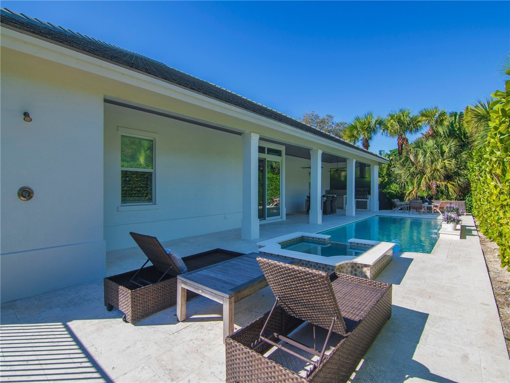 1025 Andarella Way Vero Beach, FL 32963 - Photo 34 of 36 a view of a patio with couple of chairs and potted plants
