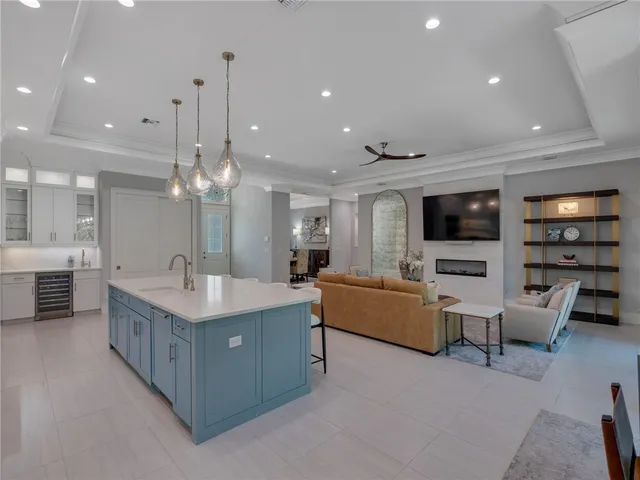 a large living room with stainless steel appliances kitchen island granite countertop a large island in the center