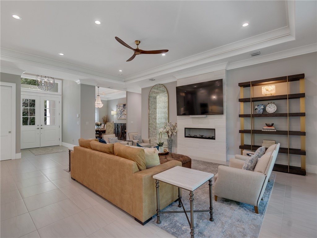 1025 Andarella Way Vero Beach, FL 32963 - Photo 7 of 36 a living room with furniture a fireplace and a flat screen tv