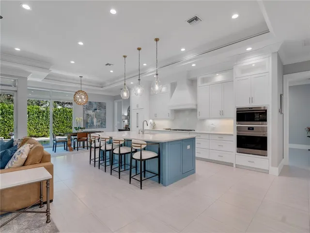 a large kitchen with a table and chairs