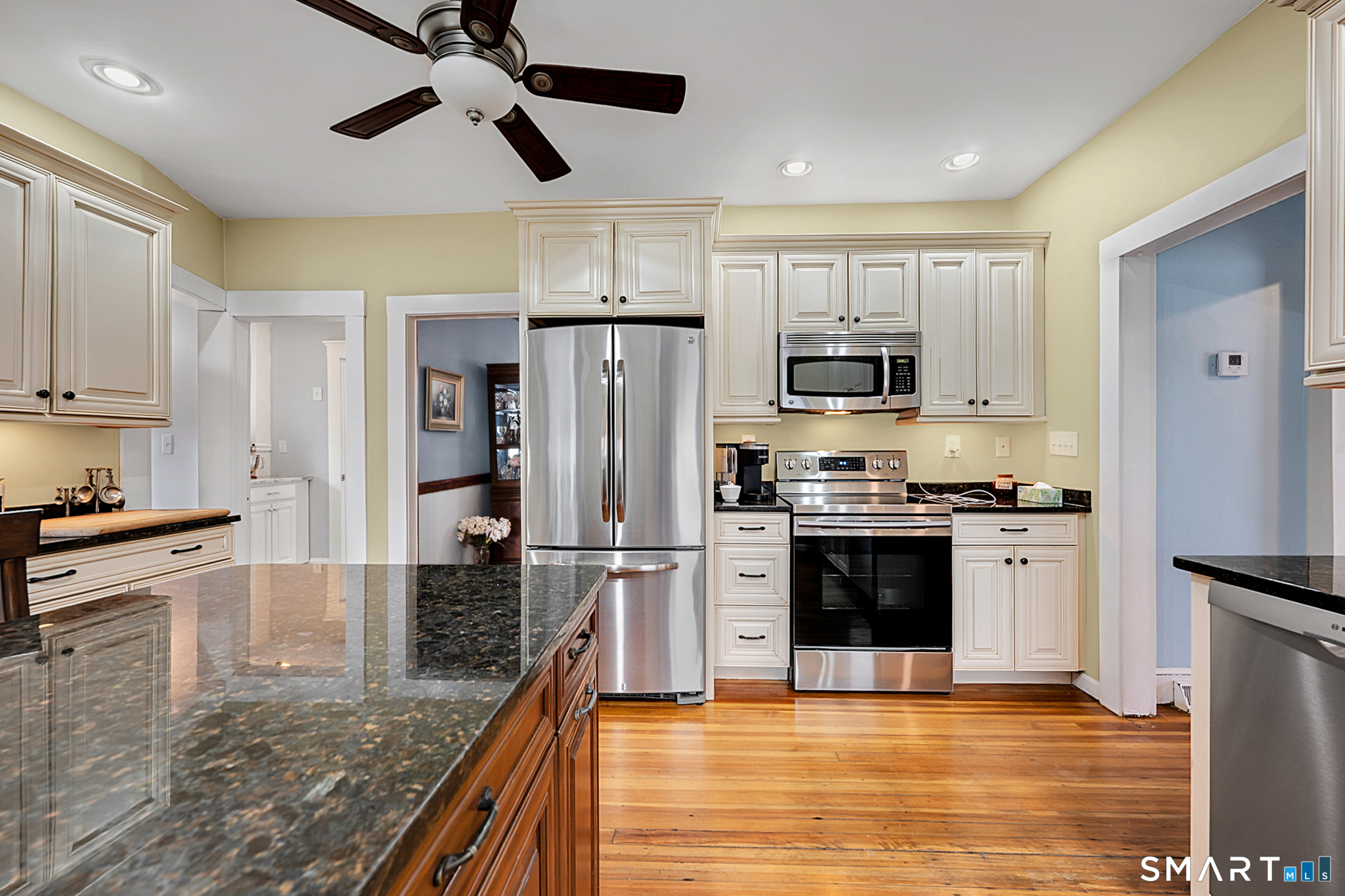 412 Reservoir Avenue Meriden, CT 06451 - Photo 12 of 32 a kitchen with stainless steel appliances granite countertop a refrigerator a stove top oven a sink and dishwasher