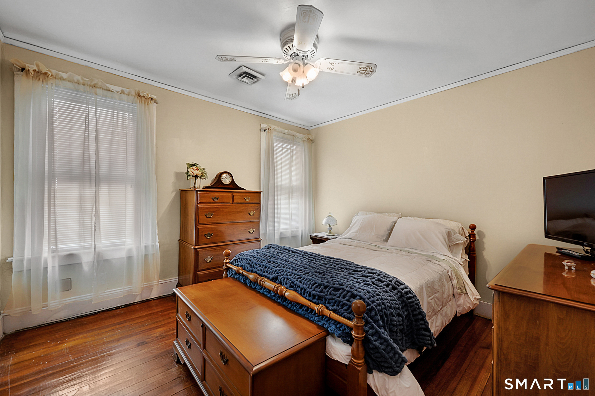 412 Reservoir Avenue Meriden, CT 06451 - Photo 19 of 32 a bedroom with a bed and a chandelier