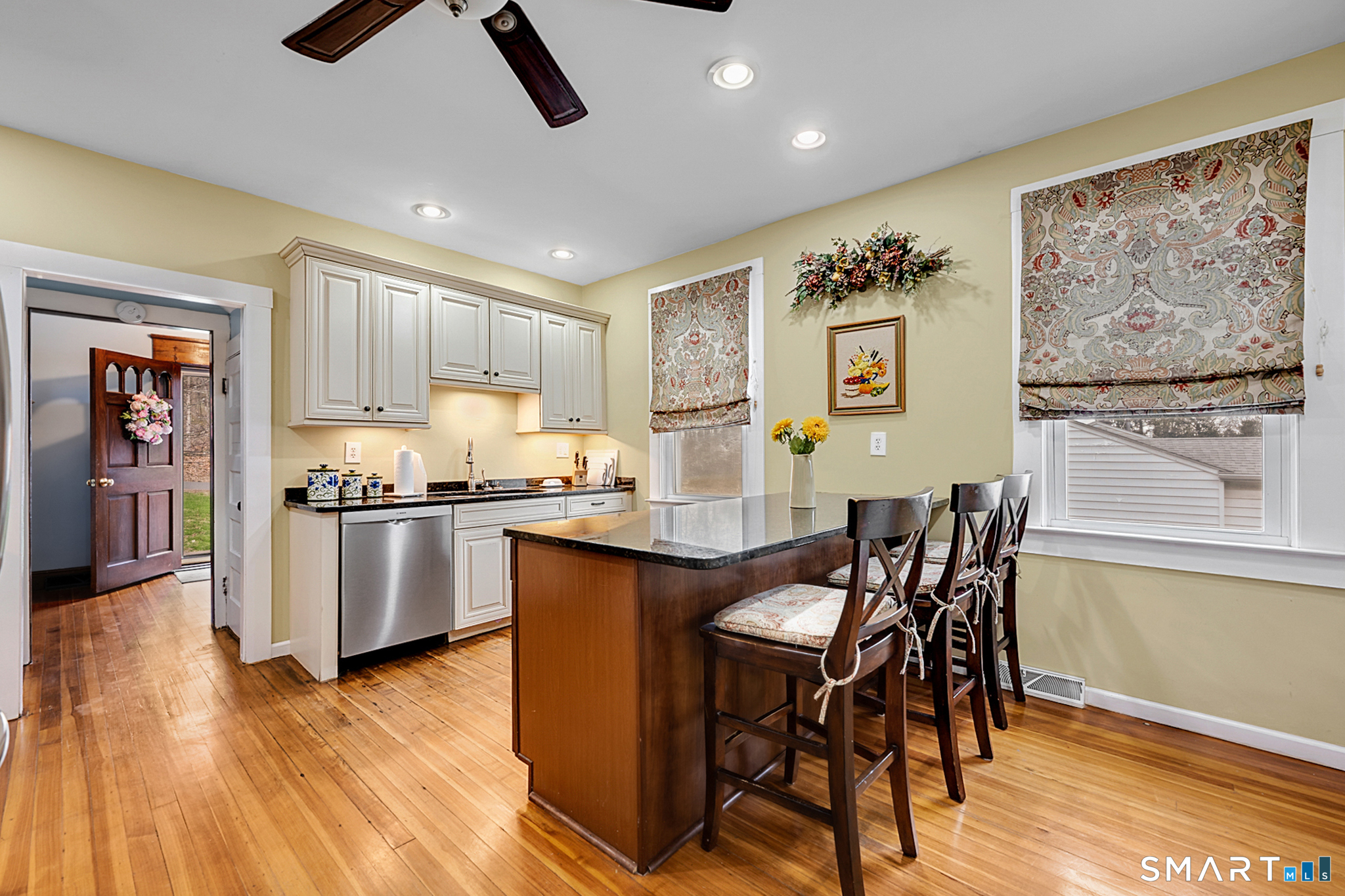 412 Reservoir Avenue Meriden, CT 06451 - Photo 10 of 32 a kitchen with granite countertop cabinets a dining table and chairs with wooden floor