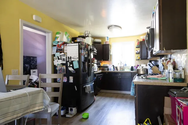 a room with lots of wooden furniture and a mirror