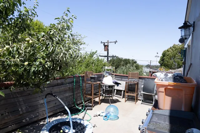 a view of a patio with table and chairs and potted plants