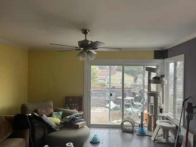 a living room with furniture and a floor to ceiling window