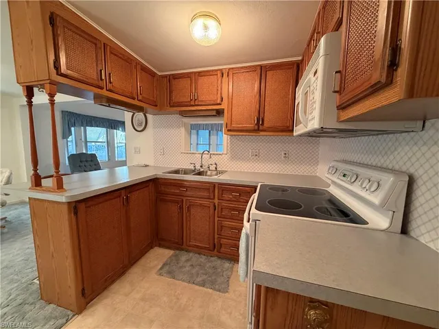 a kitchen with stainless steel appliances granite countertop a sink and cabinets