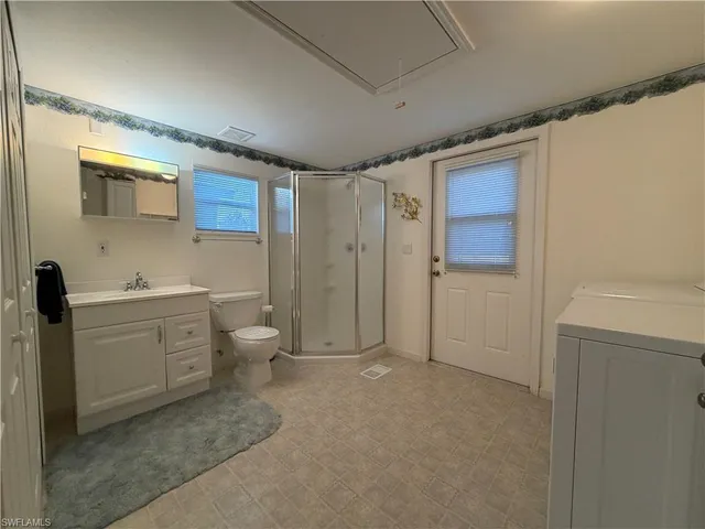 a bathroom with a toilet sink and shower