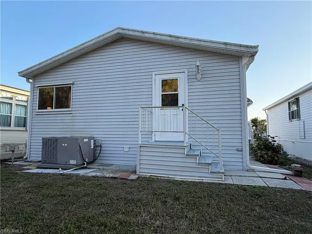a view of a house with a yard and a garage