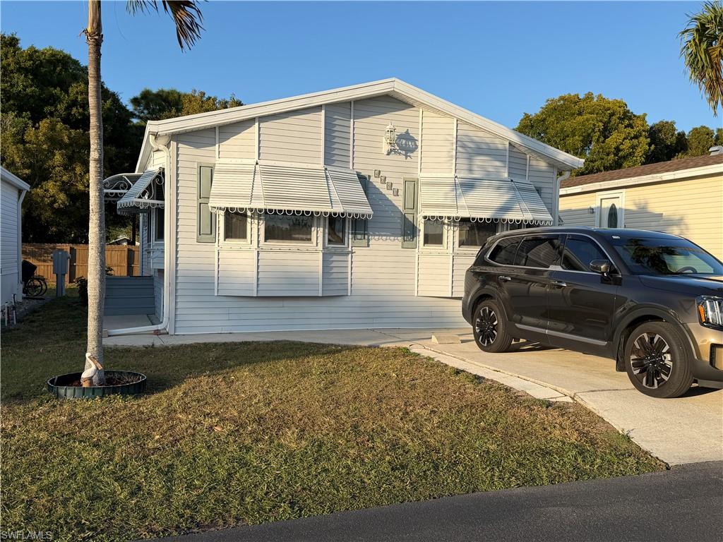 4680 Washington Way West Estero, FL 33928 - Photo 3 of 19 a view of a car parked in front of a house