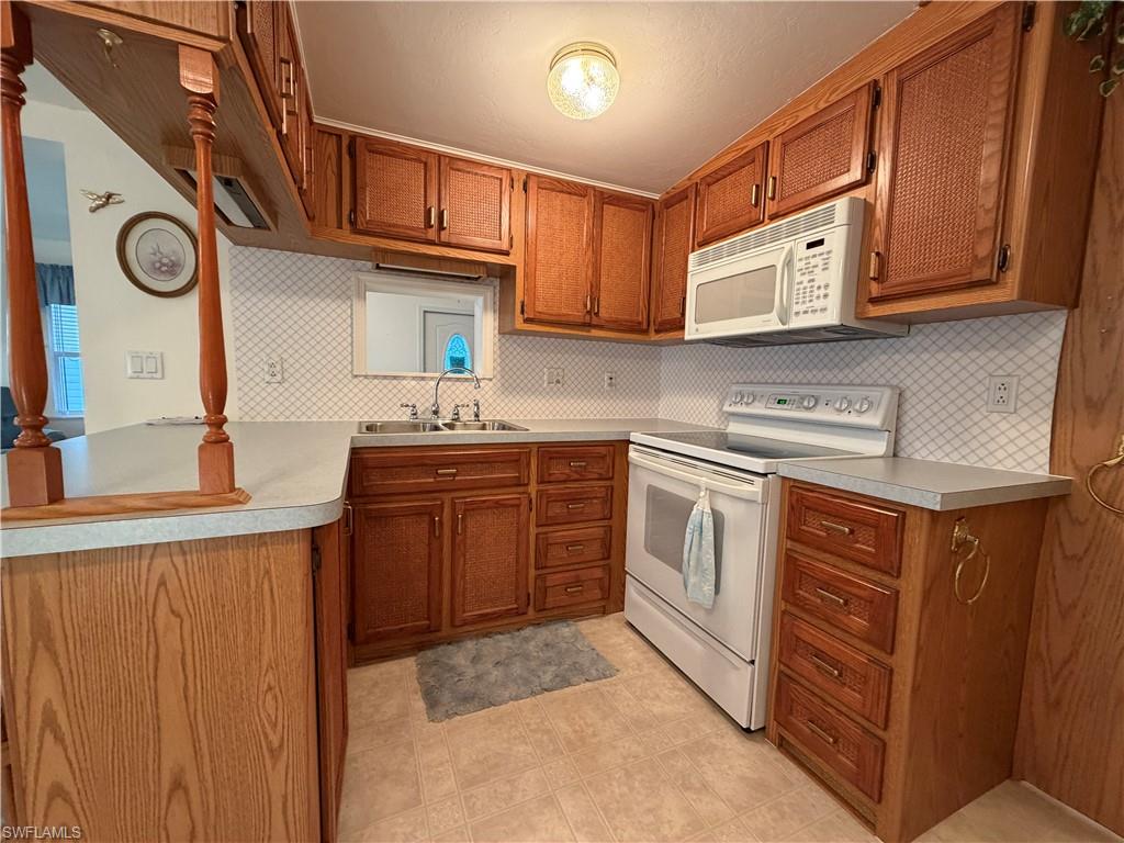 4680 Washington Way West Estero, FL 33928 - Photo 9 of 19 a kitchen with stainless steel appliances granite countertop a sink and cabinets