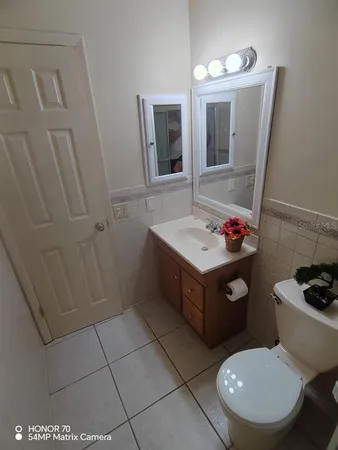 a bathroom with a sink toilet and mirror