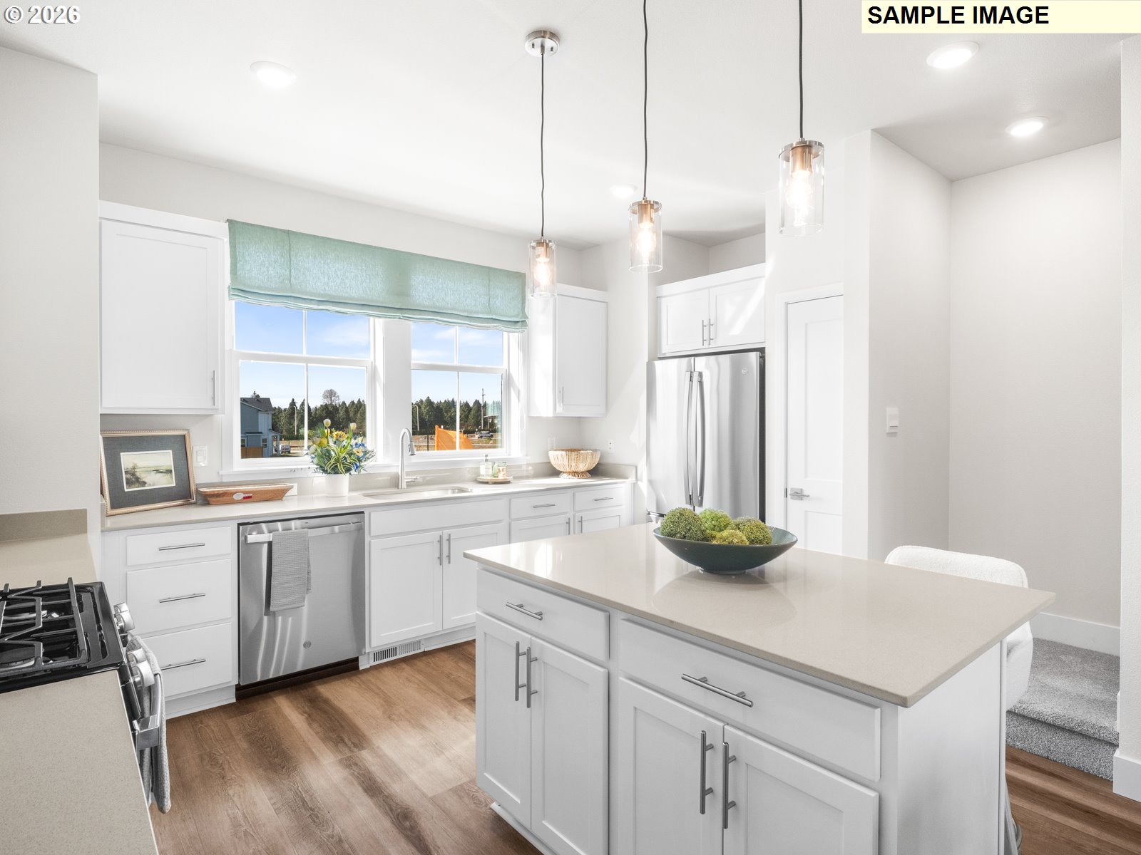 18212 Southwest Tippery Lane Beaverton, OR 97003 - Photo 5 of 29 a kitchen with white cabinets and white appliances