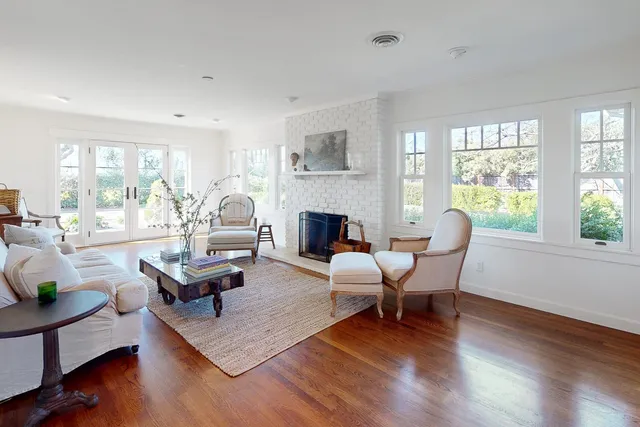 a dining room with furniture a chandelier and wooden floor