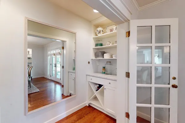a kitchen with a stove and a wooden floors