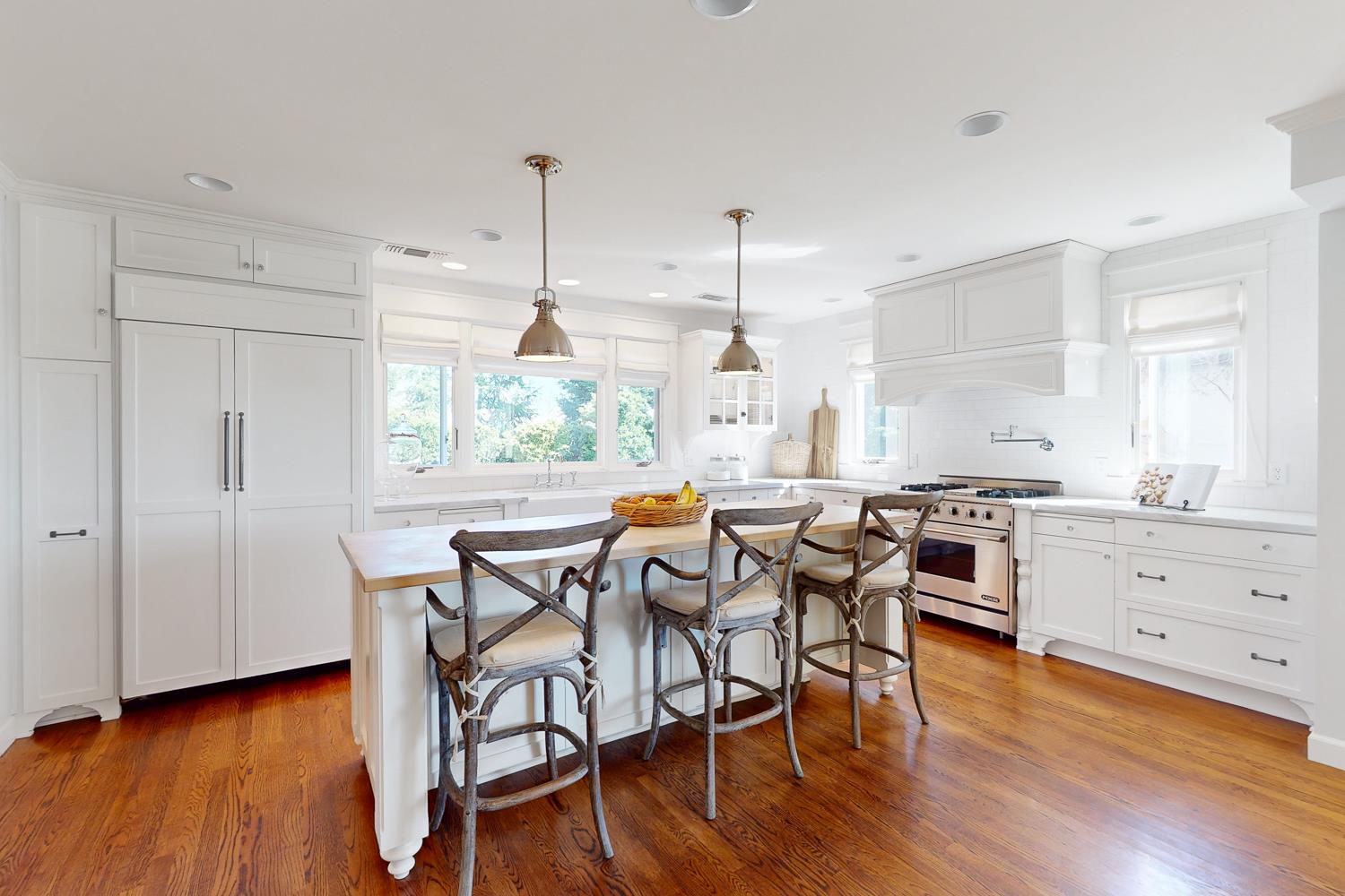 332 Wilson Road Yuba City, CA 95991 - Photo 22 of 91 a kitchen with stainless steel appliances granite countertop a table chairs stove and wooden floor