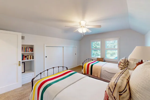 a view of a room with wooden floor and a window