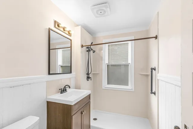 a bathroom with a sink toilet and shower