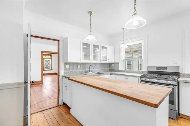 a kitchen with a stove a sink and a refrigerator