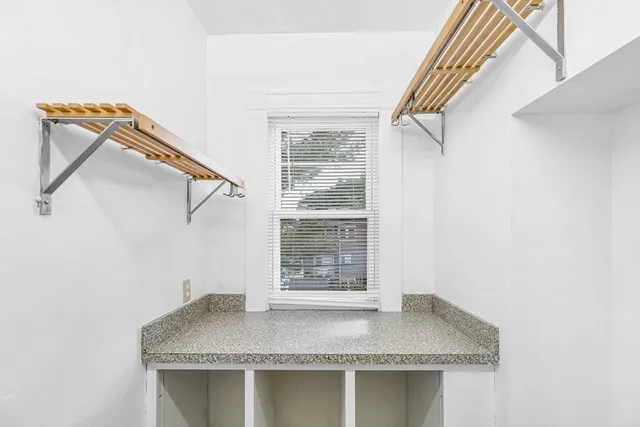 a bathroom with a granite countertop sink a mirror and shower