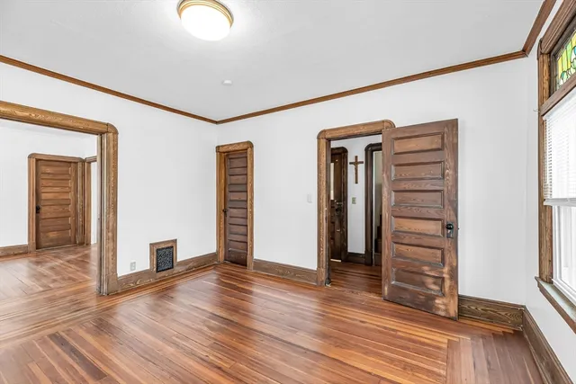 wooden floor in an empty room with a window
