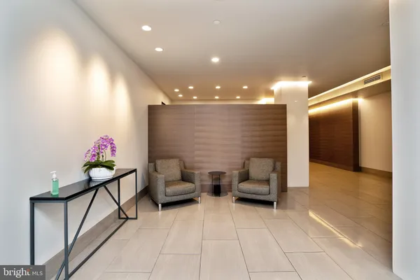 a lobby with furniture and stairs