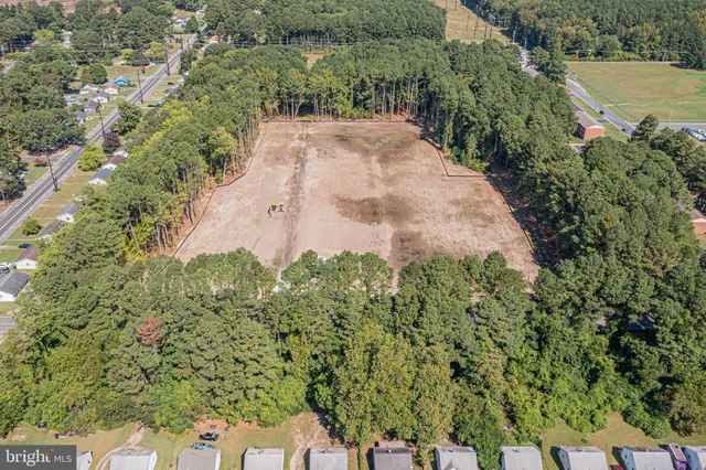 an aerial view of a house with a yard and lake view