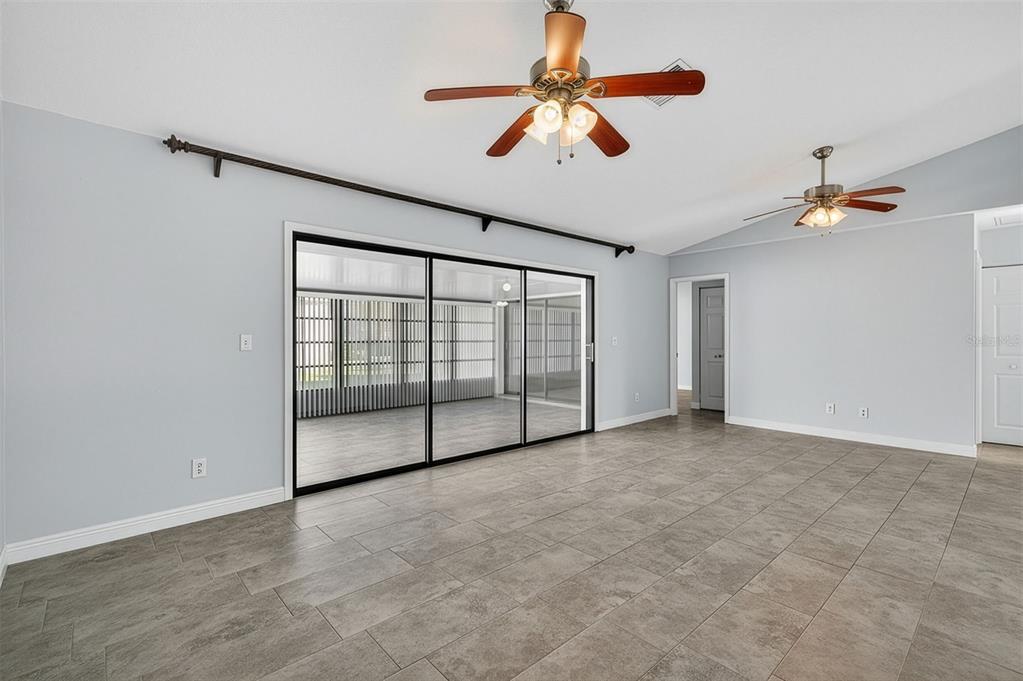 321 Windrush Loop Tarpon Springs, FL 34689 - Photo 16 of 47 an empty room with windows and fan