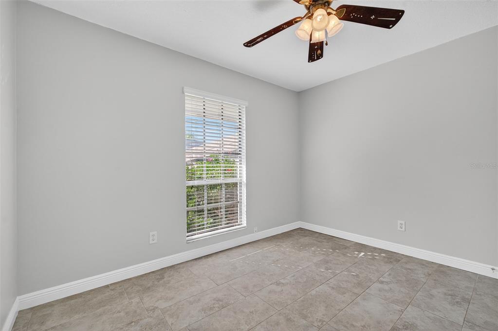 321 Windrush Loop Tarpon Springs, FL 34689 - Photo 26 of 47 an empty room with windows and fan