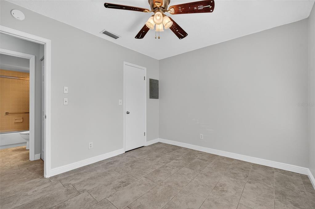321 Windrush Loop Tarpon Springs, FL 34689 - Photo 27 of 47 an empty room with chandelier fan
